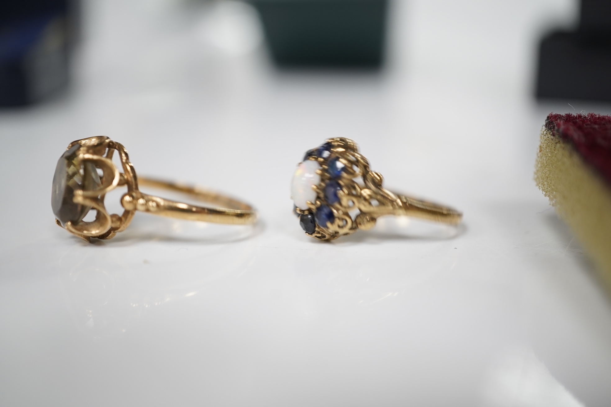 A collection of jewels, comprising: an opal and sapphire cluster ring and a citrine ring in 9ct gold, each with British hallmarks, combined gross weight approximately 4 grams; together with a pair of blue topaz and marca